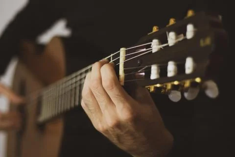 Closeup hands playing classical guitar Stock Photos