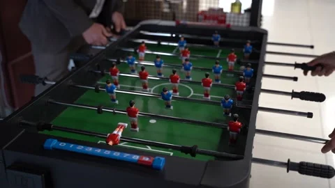 Closeup of hands playing on foosball table Stock Footage 142202810