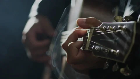 Closeup of hands playing guitar The Dark With The L Lights On A Smoke Video stock 140675684