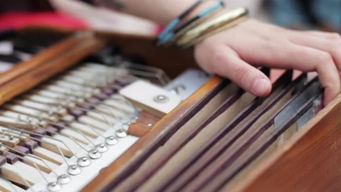 Closeup of hands playing harmonium Stock Footage 144184455