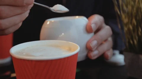 Closeup of hands pouring sugar into coffee indoor 스톡 동영상 104732043