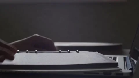 Closeup hands put diary on laptop leaf through pages full of personal notes. Vidéo 152168254