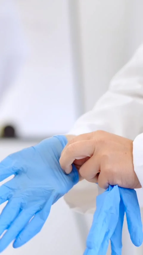 Closeup of hands putting on sterile gloves Stock Footage 257137970