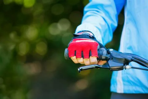 Closeup of hands in red protective gloves holding handlebar. Stock Photos