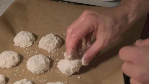Closeup of hands rolling cookie dough in flour before baking, capturing homemade Stock Footage 319900763