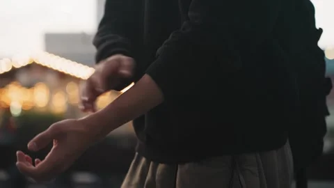 Closeup hands rolling up sleeve outdoors, barista preparing shift near Stock Footage 332368831