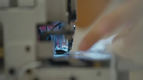 CloseUp of Hands Sewing Soft Fabric with Machine Stock Footage 319028987