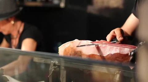 Closeup of hands slicing prosciutto Stock Footage 64439090