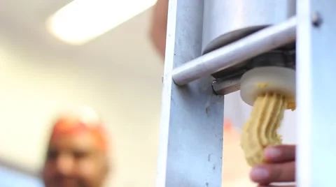 Closeup of hands squeezing dough by a machine Stock Footage 64442371