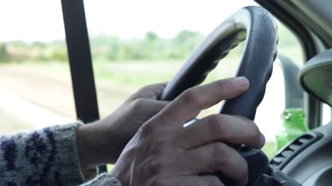 Closeup of hands on the steering wheel while driving car Stock-Footage 158836241