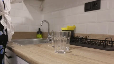 Closeup hands taking glass cups from cabinet, home routine Stock Footage 325594570