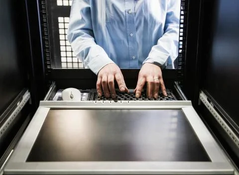 Closeup of a the hands of a technician working on data from a computer server 스톡 사진