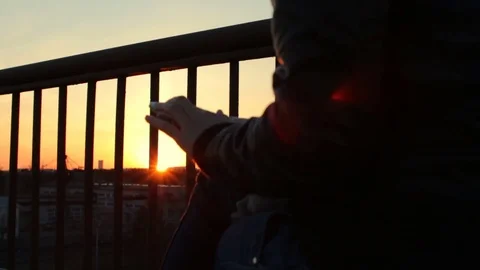 Closeup hands texting using app on smart phone at balcony roof penthouse sunset Stock-Footage 75171480