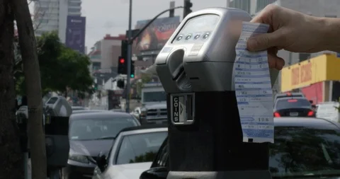 Closeup of hands torching parking ticket by meter Stock Footage 105514666
