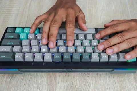Closeup Of Hands Typing On A Customized Keyboard Stock Photos
