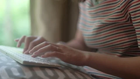 Closeup hands typing on keyboard with green blurred background. Stock Footage 135347174