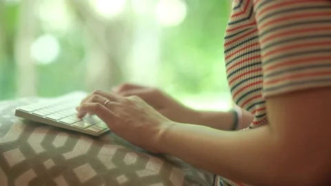 Closeup hands typing on keyboard with green blurred background. Stock Footage 135347176