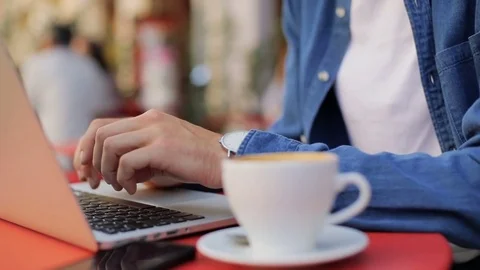 Closeup hands typing on a laptop keyboard. Man sitting outdoors in the cafe Stock Footage 81050383