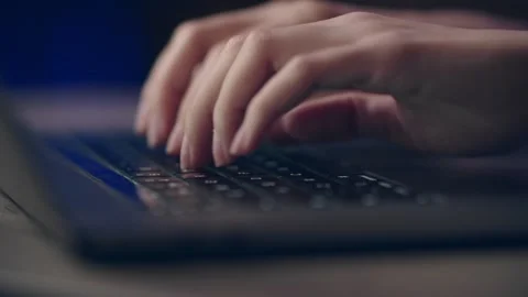 Closeup of hands typing on laptop keyboard, emphasizing technology and Stock Footage 277045528