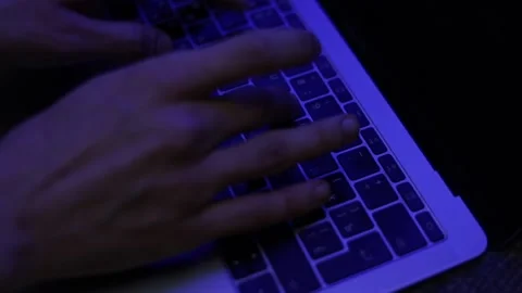 Closeup hands typing on laptop under blue neon light Stock Footage 229705979