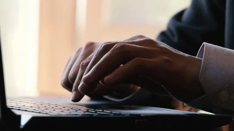 Closeup on hands typing words on a laptop in the office Stock Footage 76305231