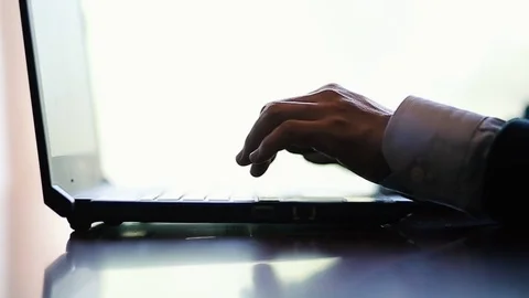 Closeup on hands typing words on a laptop in the office slow motion 動画素材 76305486