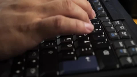 Closeup of hands typingworking on a laptop computer keyboard with black keys 库存影片 279285193
