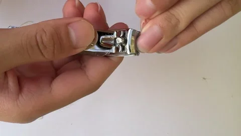 Closeup Of Hands Using Nail Clippers On White Background Stock Footage 313542560