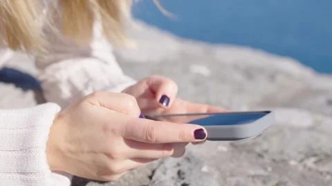 Closeup of hands using phone outdoors. Video stock 288326960