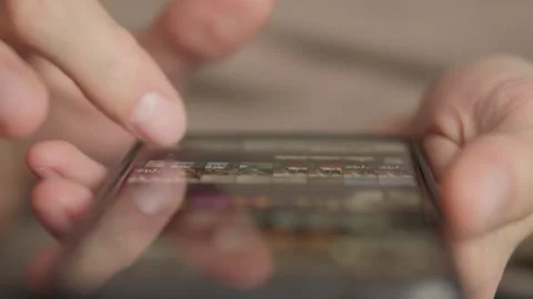 A closeup of hands using a smartphone highlights the importance of digital Video stock 317021757