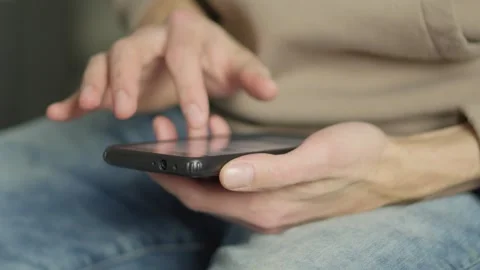 A closeup of hands using a smartphone highlights the casual yet important Stock Footage 317021815