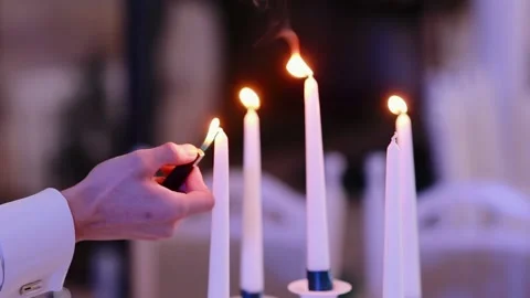 Closeup hands of waiter lighting candles in elegant restaurant Stock Footage 132697280