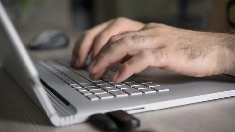 Closeup of hands working and typing on laptop keyboard on table Stock Footage 91072807