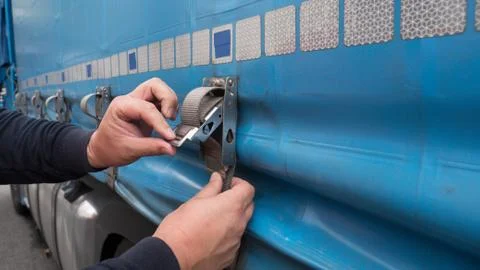 Closeup hands working cargo strap. Stock Photos