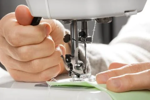 Closeup of hands working on sewing machine Stock Photos
