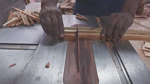 Closeup of hands working with wood on a table saw in a carpentry workshop Stock Footage 266864514