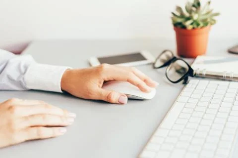 Closeup of hands in the workplace at the computer in the office Stock Photos