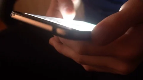 Closeup of hands of a young man flipping through the news on the smartphone Stock Footage 83621750