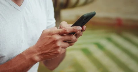 Closeup Hands of Young Man Using Smartphone, Typing Message, Using Apps for Stock-Footage 148347932