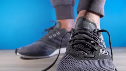 Closeup of handsMan is going to do sports work out - tying the laces on sneakers Stock Footage 101188789