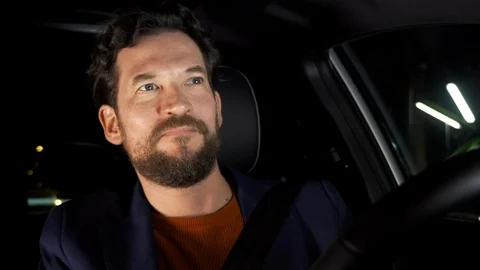 Closeup of handsome man happy driving car at night after the end of coronavir Stock Footage 130075310