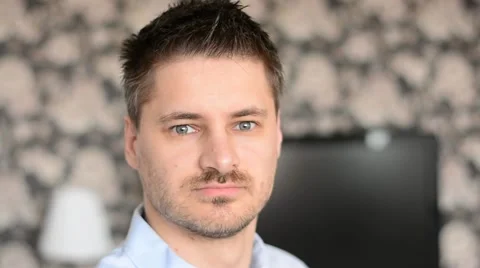 Closeup of handsome young man smiling in his flat. Stock Footage 53746926