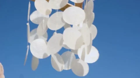 Closeup of Hanging seashells mobile blowing in the wind. Stock Footage 165315686