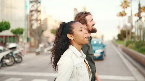 Closeup, happy interracial couple going down the cross the road holding hands Stock Footage 226896482