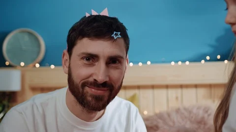 Closeup happy man playing with his daughter dressing for a birthday party Video stock 112263518