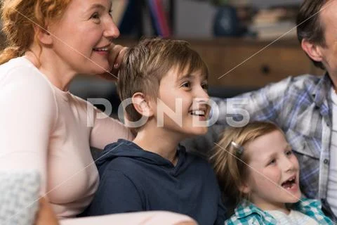 Closeup Of Happy Smiling Family Sitting On Couch Watching TV, Parents Spending Stock Photos
