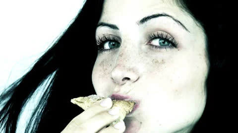 Closeup of happy woman eating croissant looking and smiling Stock Footage