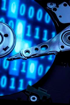 Closeup of an hard disk under a blue light with binary code Stockfoto's