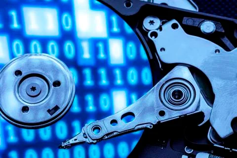 Closeup of an hard disk under a blue light with reflection of code 写真素材