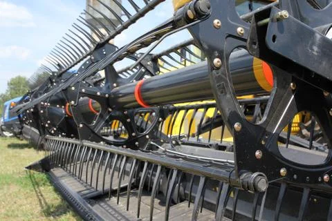 Closeup of harvesting machinery while working the field. 스톡 사진